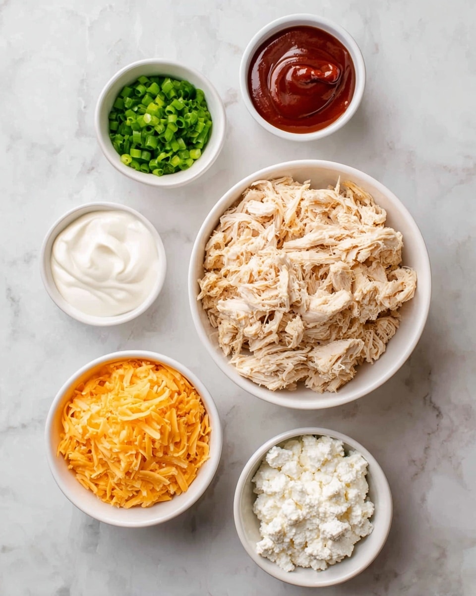 The image shows six white bowls arranged on a white marbled surface, each holding different ingredients. The largest bowl in the center contains light beige shredded chicken with a fibrous texture. Moving clockwise from the top left, the smallest bowl holds bright green chopped scallions, next to it is a medium bowl filled with smooth, creamy white sour cream. Beside that is another medium bowl containing a dark red, thick sauce, likely hot sauce. Below the shredded chicken bowl is a small white bowl with white crumbly cottage cheese. To the left is a small bowl filled with thin, bright orange shredded cheddar cheese. Everything is cleanly arranged with no utensils visible. Photo taken with an iphone --ar 4:5 --v 7