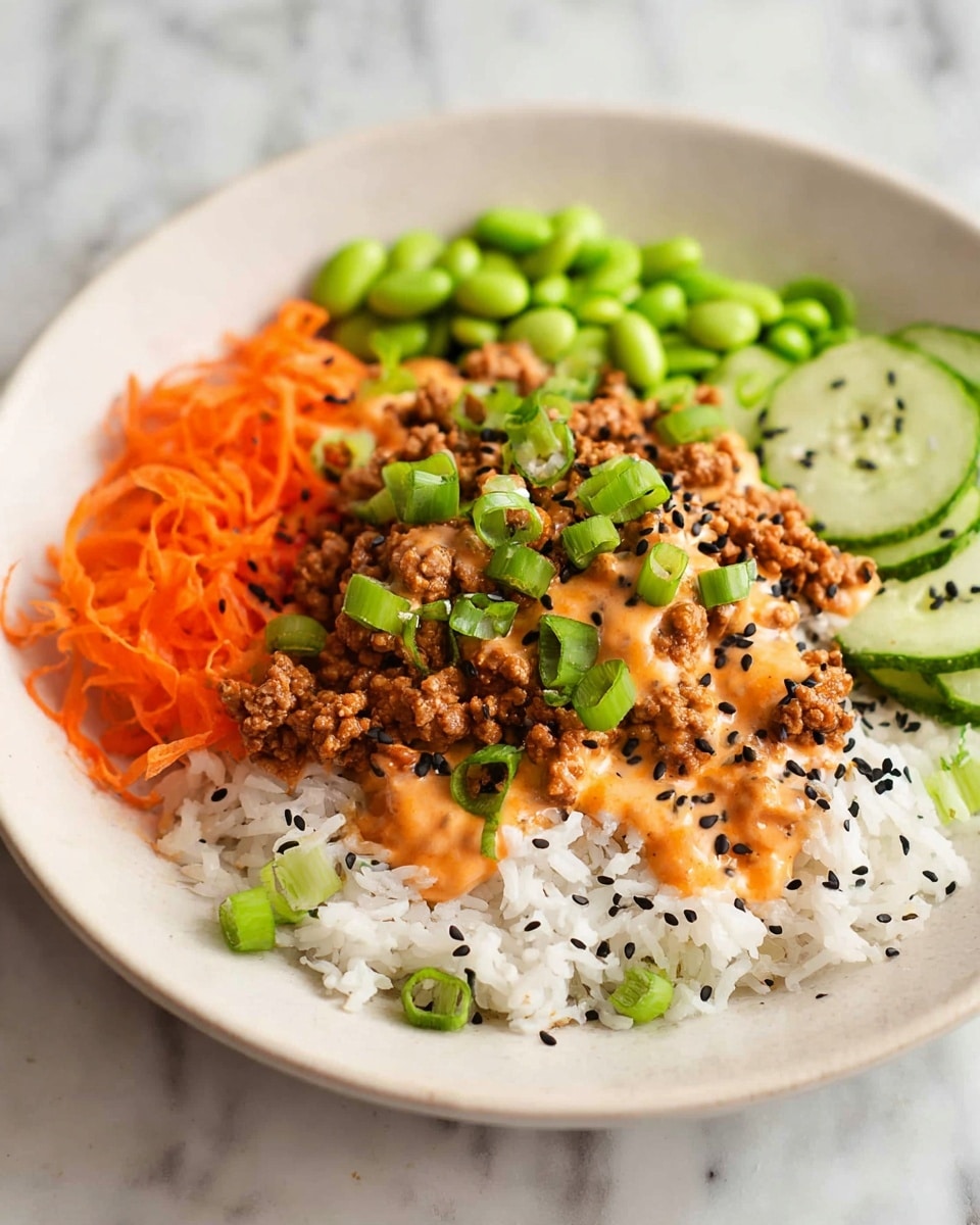 A white bowl filled with a colorful dish placed on a white marbled surface, showing layers of white rice at the bottom left, topped with cooked ground meat covered in creamy orange sauce in the center, and garnished with chopped green onions and black sesame seeds scattered over the meat and sauce. To the top right of the bowl, there are sliced green cucumbers, and on the top left, shredded orange carrots alongside bright green edamame beans are arranged neatly. The textures vary from the soft rice and meat to the fresh, crunchy vegetables, all in a balanced and vibrant presentation. Photo taken with an iphone --ar 4:5 --v 7
