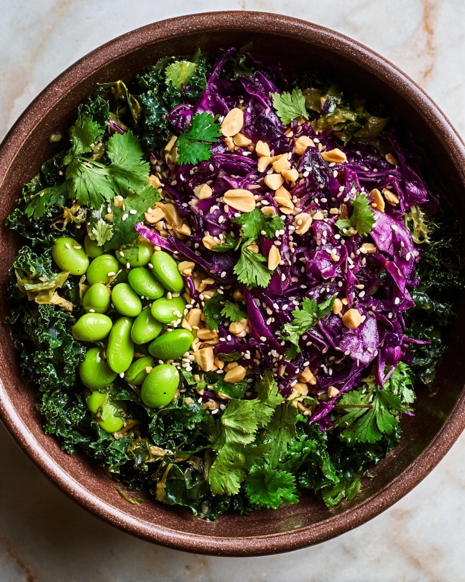 A round brown bowl filled with a colorful salad on a white marbled surface. The salad has four main layers: at the bottom, there are dark green kale leaves mixed with light green cucumber pieces, then bright purple shredded cabbage spread evenly on top. On one side, there are bright green edamame beans scattered, and on the top-left, golden brown tofu cubes. Light tan and black sesame seeds are sprinkled evenly over the whole salad, adding texture and contrast. The bowl is full and the colors stand out vibrantly against the bowl's brown color and the soft white marbled background. photo taken with an iphone --ar 4:5 --v 7