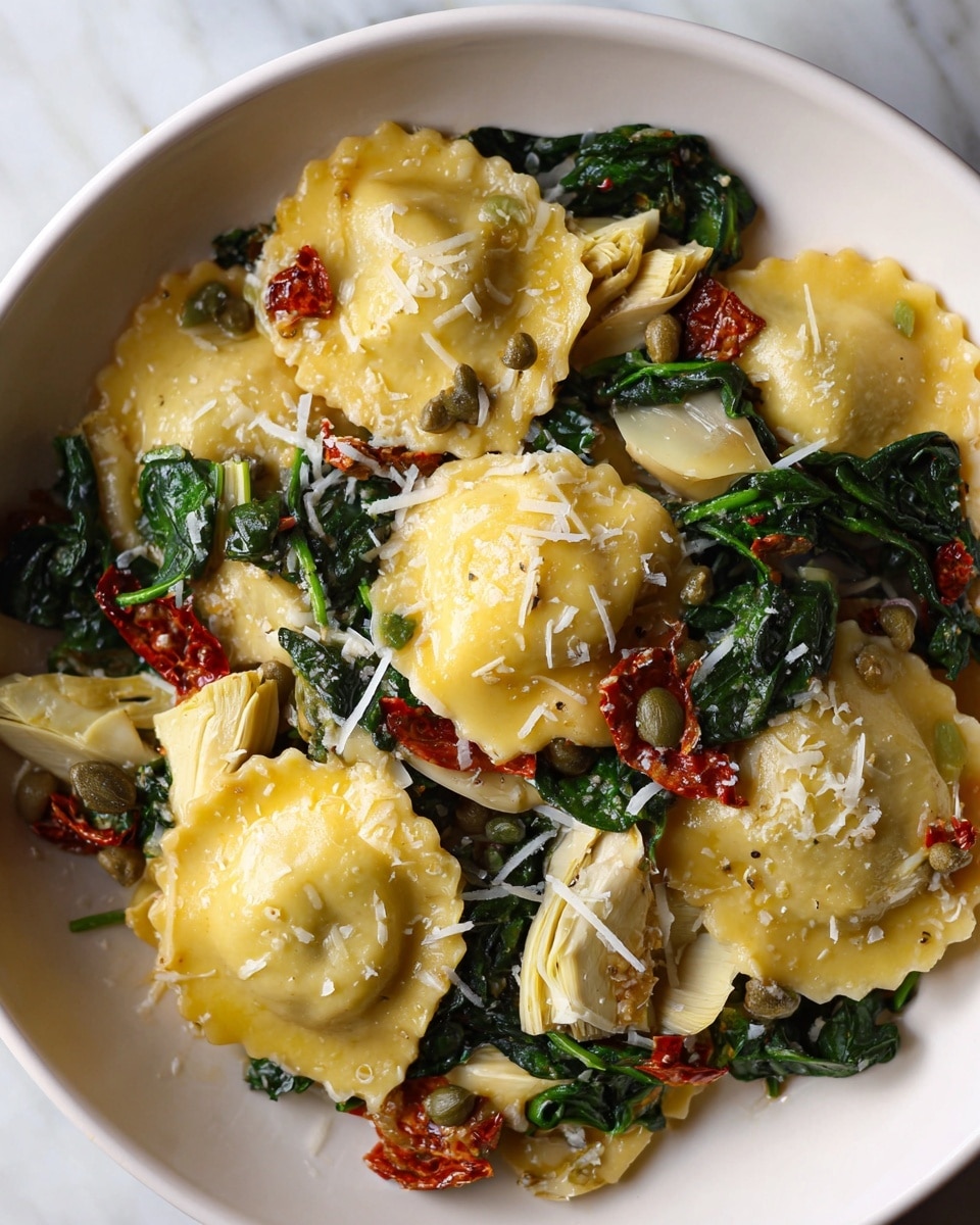 A close-up view of ravioli pasta served in a white bowl, showing about four to five ravioli pieces on top. Each ravioli is yellow with a soft, slightly shiny texture, topped with small white shredded cheese bits. Around and between the ravioli are dark green spinach leaves that look wilted and tender, with light beige artichoke slices scattered throughout, some pieces cut into small chunks. There are also small pieces of reddish sun-dried tomatoes dotted across the dish, and tiny green capers adding texture. The arrangement is natural and slightly messy, emphasizing the fresh ingredients on a white marbled surface. Photo taken with an iphone --ar 4:5 --v 7