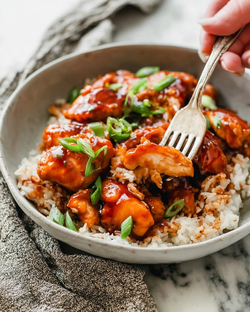 A close-up view of a white bowl filled with a single layer of cooked rice mixed with bright yellow pineapple cubes, small bits of red chili flakes, and tiny green herb pieces scattered throughout. The rice looks fluffy with some grains slightly browned, giving a mix of off-white and light brown colors. At the top edge of the bowl, a small section of fresh green pineapple leaves can be seen, adding color contrast. The bowl is placed on a white marbled texture. Photo taken with an iphone --ar 4:5 --v 7